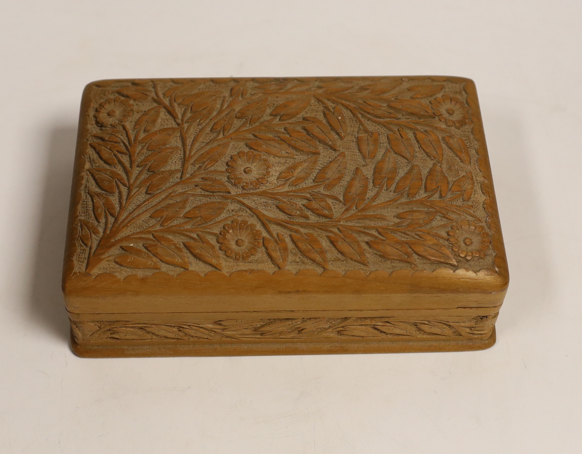 A group of Indian bronze sweet moulds, contained in a carved teak box